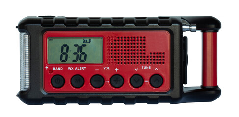 Battery-powered emergency weather radio that has a hand crank and solar panel for backup on a white...