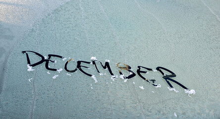 december is written on the windshield of the car,on morning frost New Year. Winter concept