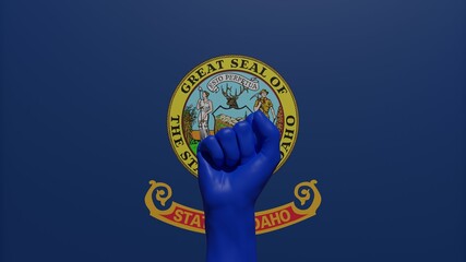 A single raised blue fist in the center in front of the US state flag of Idaho