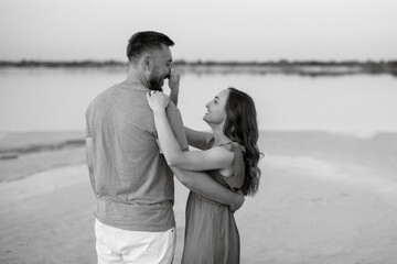 young couple in orange clothes with dog