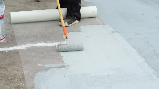 Hand painted gray flooring with paint rollers for waterproof, reinforcing net,Repairing waterproofing deck flooring.	