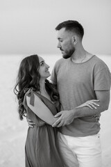 young couple in orange clothes with dog