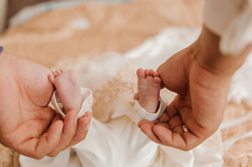 little baby feet baby on fathers arm