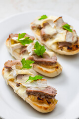 baguette baked with meat, onion and cheese