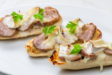 baguette baked with meat, onion and cheese