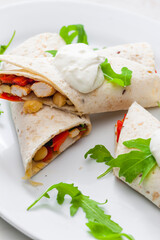 tortilla filled with chicken meat, red pepper and beans