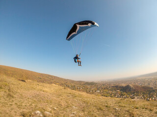 Man flying extreme paragliding alone at sunny day, freedom concept. Budapest