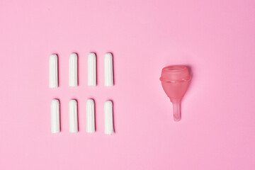 hygienic feminine tampon for menstruation, menstrual cup on pink background
