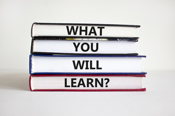 What you will learn symbol. Concept words What you will learn on books on a beautiful white...