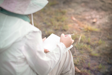girl sitting painting on a sunny day