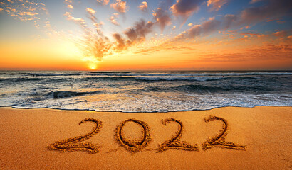 Happy New Year 2022! Written 2022 on the beach. Happy New Year 2022 is coming concept sandy.