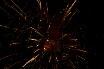 Salute in the sky. Explosion of fireworks in the night sky. Firecrackers flapping sparks in a dark space. Festive fireworks.