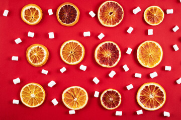 Dried oranges with marshmallow on red background. Christmas pattern.