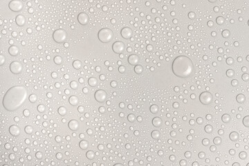 Water drops on white background texture. backdrop glass covered with drops of water. gray bubbles in water