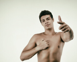 Fototapeta premium Attractive guy points a finger.