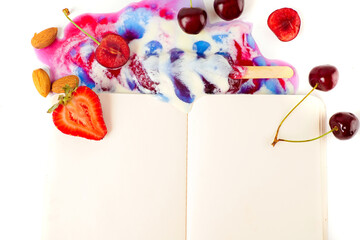 Flat lay of open empty notepad with fresh berries and melted ice cream