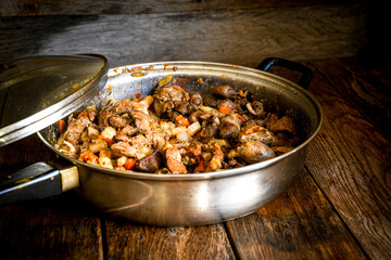 Fried chicken liver in a frying pan on the kitchen table. Home cooking in the village.