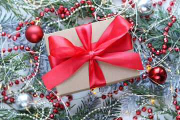 greeting christmas card. christmas background. gift box and Christmas decorations on the background of fir branches
