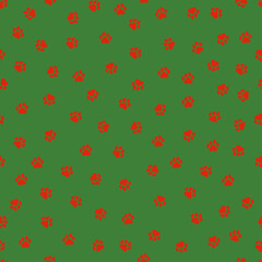 Seamless pattern with Christmas decoration. Red paws on green background.