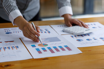 Close up of hand Business Woman examines business graphics
