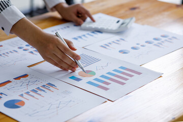 Close up of hand Business Woman examines business graphics