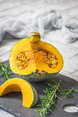 Sliced green sombra pumpkin, cucurbita maxima, on gray background, vertical