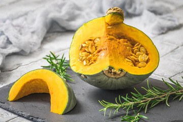 Sliced green sombra pumpkin, cucurbita maxima, on gray background