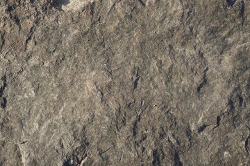 The surface of a huge chipped stone. Granite. Texture. Relief. Background.