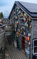 Bernard, ME - USA - Oct.15,2021: Vertical view of an old wooded shingled workshop, covered with...