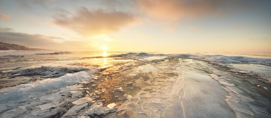 Panoramic view of the snow-covered shore of the frozen Baltic sea at sunset. Ice fragments...