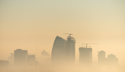 City skyline at sunrise, foggy morning