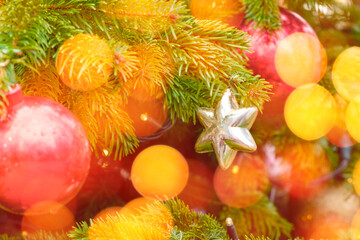 Gold star and garland lights, toys decoration on the Christmas tree on the background light bokeh.