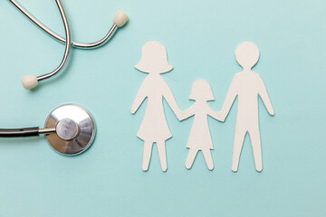 Family health care therapy medical concept. Flat lay family cutout symbol model stethoscope on...