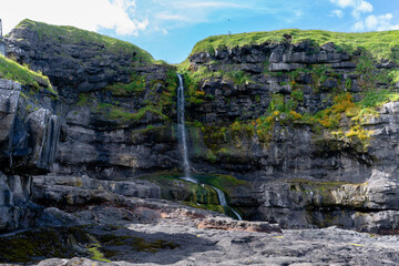 View of the statue of the Seal Woman - K&oacute;pakonan, the village, waterfall in the Faroe Islands in the island of Kalsoy 