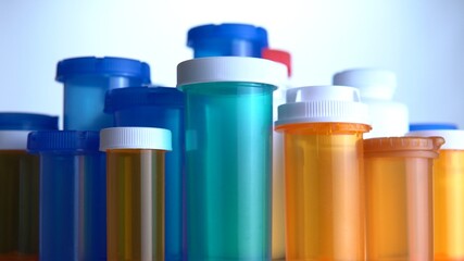 Various pills bottles macro close up shot. Production of medicines bottles. Pharmaceutical concept of healthcare, pharma industry, medication and drugs production. Medical research and trials.
