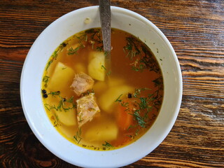 Fish soup with salmon on the table