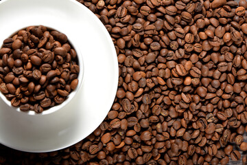 White coffee mug filled with coffee beans