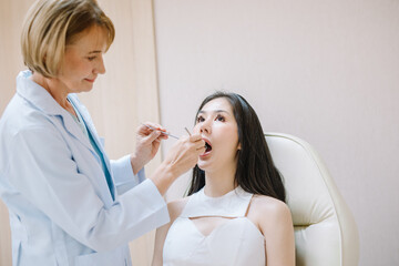 Woman having teeth examined at dentists