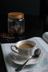 Morning reading a magazine with a little cup of cofee