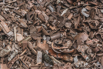A bunch of old dirty rusty metal and iron waste to recycle in a landfill steel trash background