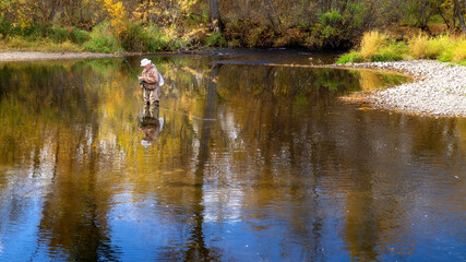 Man works on his fly line on the Boise River