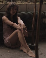 woman in pink dress in the dark studio