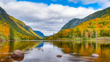 Naklejka premium Wonderful and colorful Jacques-Cartier valley and its vibrant foliage at Fall, Jacques-Cartier national park, Quebec, Canada