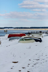 Upturned row boats have been left moored on the beach on the Suffolk coast. They have been covered in snow after a rare snow storm covers the area