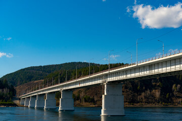 Long concrete bridge over the river on massive pillars.