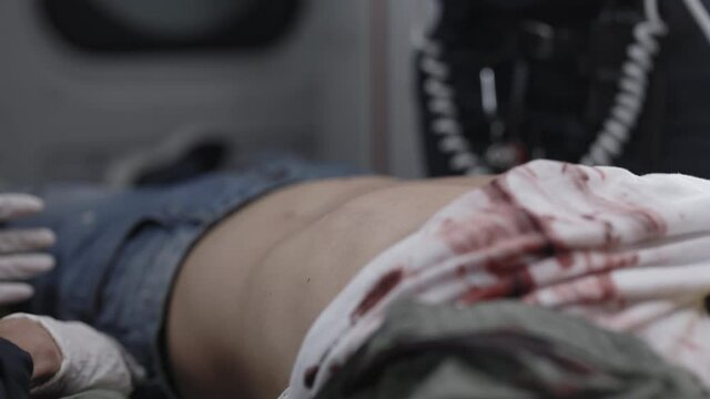 Paramedics stimulating patient heart with defibrillator