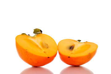 Two halves of sweet persimmon, close-up, isolated on white.