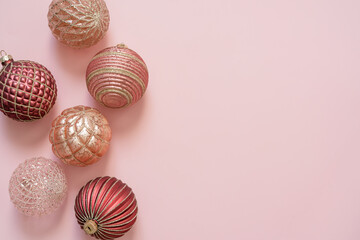 Christmas and New Year background. Greeting card, banner, poster. Christmas decoration balls on pink background. Top view with copy space..
