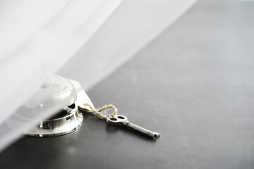 A shiny silver metal bell at the hotel reception. A table in the hotel at the concierge with a bell...