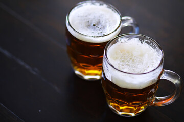 Glass of fresh beer on a wooden table. Lager beer mug on stone table. Top view with copy space